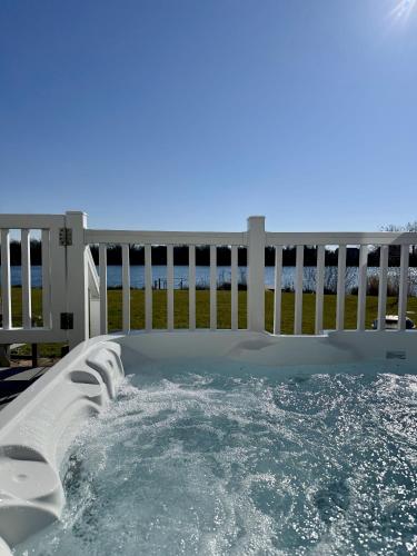 a jacuzzi plunge pool on a deck at Medway Hot Tub Lodge in South Cerney