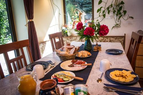 a table with plates of food on it at Kétkerék Vendégház - a mátrai szállás in Matraszentlaszlo