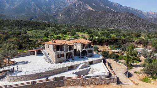 an aerial view of a building with mountains in the background at Elevi in Tiros