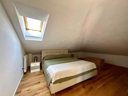 a small bedroom with a bed and a window at Casa Sarina Modern apartment with city and sea view up to 6 ppl garage on request in La Spezia