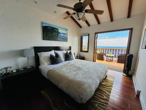 a bedroom with a bed with a view of the ocean at Hillside Avalon escape w pool & panoramic views in Avalon