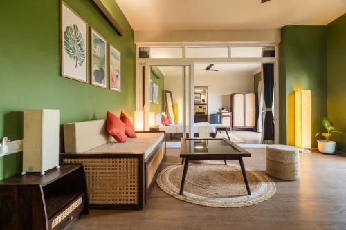 a living room with a couch and a table at Kssemya in Mandrem