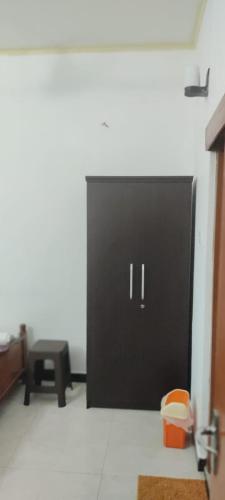 a black door in a room with a table at Trellis Homes in Colombo