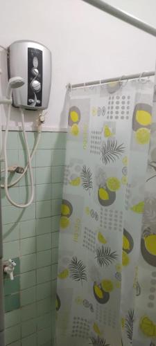 a bathroom with a shower curtain with fruit on it at Trellis Homes in Colombo