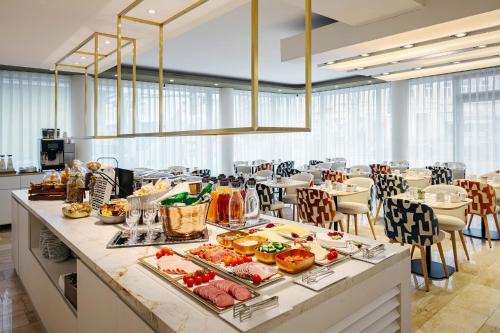 a buffet line with food on it in a restaurant at Eurostars Embassy in Vienna