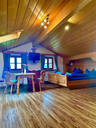 a bedroom with two beds and a table and chairs at Ferienwohnung Beim Raffner in Ruhpolding