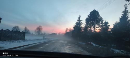 a view from a car of a snow covered road at Żurawisko - Domki wśród natury in Jesiona