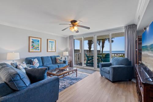 a living room with a blue couch and chairs at Romar Tower Unit 1A in Orange Beach
