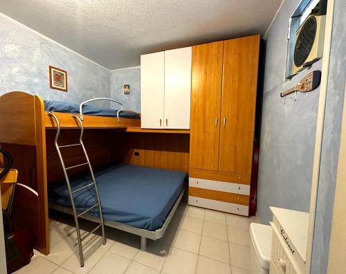 a small room with a bunk bed and a cabinet at Rio Piccolo Apartment in Principina a Mare