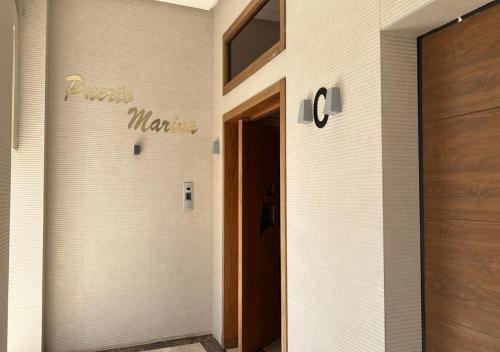 a door to a room with a sign on the wall at PUERTO MARINA ASILAH in Asilah