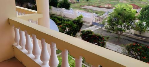 a balcony of a building with a view of a street at Lord's Hands Guesthouse Hotel in Winneba