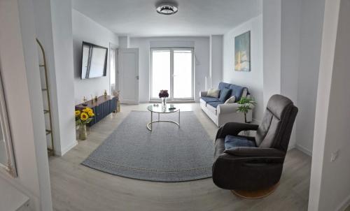 a living room with a couch and a table at Tudor Central Apartment in Bistriţa