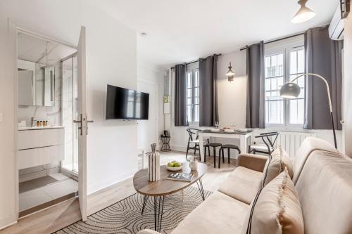 un salon avec un canapé et une table dans l'établissement A21#Republique # Marais # 1BedRoom # Paris03 # AC, à Paris