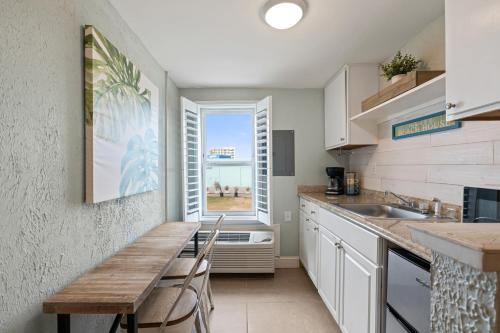 a kitchen with a table and a sink and a window at Beachview Unit 321 in Gulf Shores