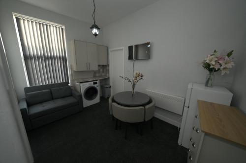 a small living room with a couch and a table at Charming Oxford Apartment in Telford - Flat 1 in Telford
