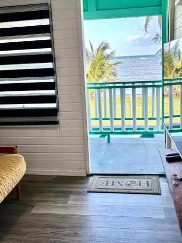 a door to a balcony with a view of the beach at Mami Ana Beach House, The Oceanfront Rest Hideaway ! in Ceiba