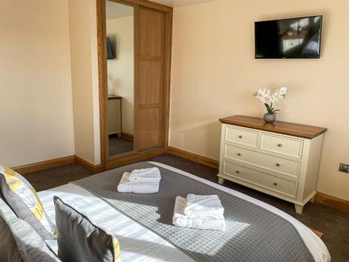 En eller flere senge i et værelse på Branwen Holiday Cottage