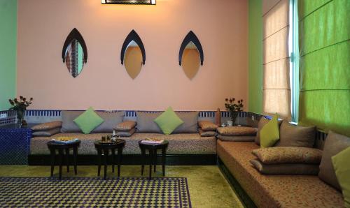 a living room with a couch and chairs and mirrors at Ibis Marrakech Palmeraie in Marrakech