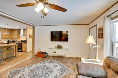 a living room with a couch and a ceiling fan at Stylish Chetek Hideaway with Lake and Dock Access! in Chetek