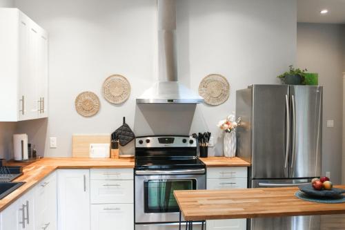 a kitchen with a stove and a refrigerator at Sooke Getaway - Relax & Recharge in Nature, Private 7min to Sooke in Sooke