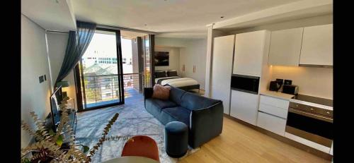 a living room with a couch and a bedroom at 601 The Cosmopolitan in Cape Town