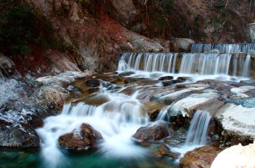 a stream of water flowing over rocks in a waterfall at Domaso front lake in Domaso