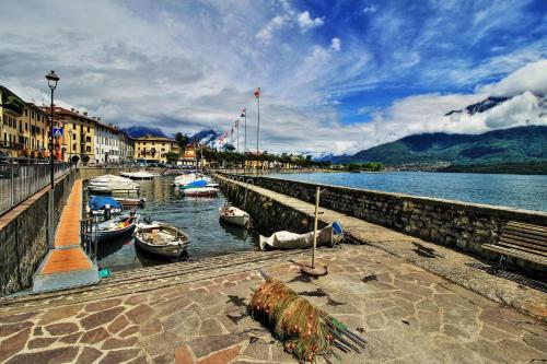 a group of boats are docked in a river at Domaso front lake in Domaso