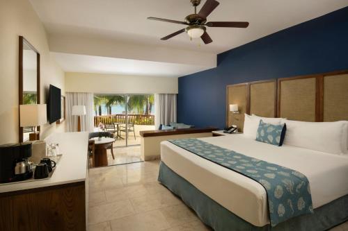 a bedroom with a bed and a living room at Impressive Premium Punta Cana - All Inclusive in Punta Cana