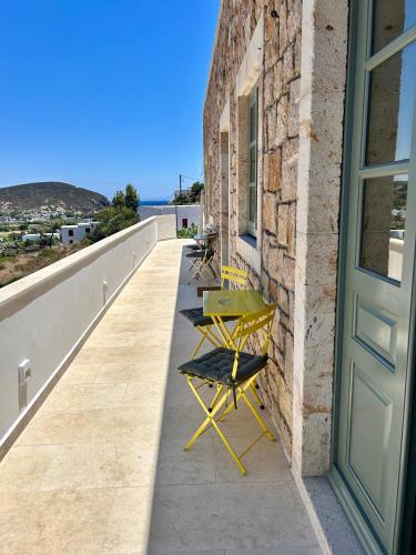 a balcony with a table and chairs on a wall at VERANNA Patmos Studio2 in Patmos