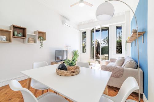 un salon avec une table et des chaises blanches dans l'établissement Promenade des Anglais 2 Bdr Large Terrace, à Nice