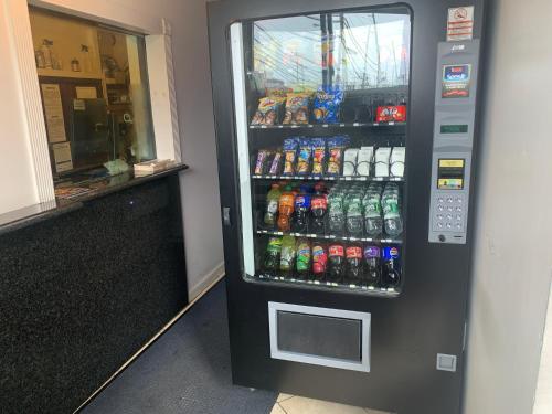 a soda vending machine in a store with drinks at Domino Inn in North Bergen