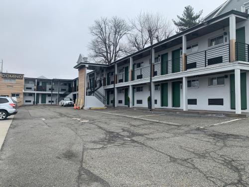 an empty parking lot in front of a building at Domino Inn in North Bergen