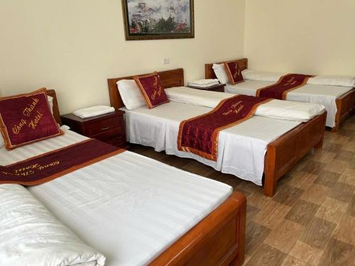 a group of four beds in a room at Công Thành Hotel in Lao Cai