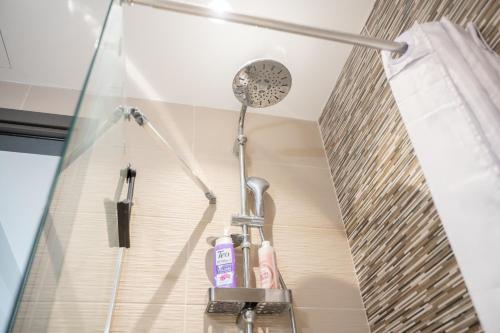 a bathroom with a shower with a shower head at Callas Home in Kos