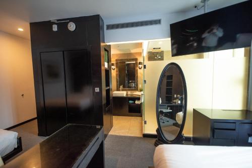 a room with a room with a mirror and a room with a room at The One Boutique Hotel in Queens