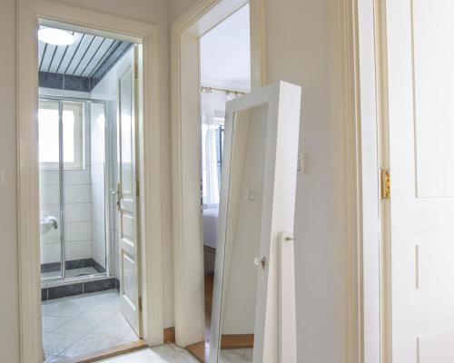 a bathroom with a door leading to a shower at Montesan Luxury Apartments Sveti Stefan in Sveti Stefan