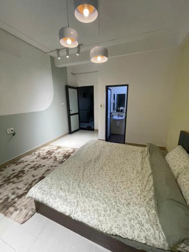 a bedroom with a large bed and two lights at Luxe Paradise 21 Nguyen Van Troi in Hanoi