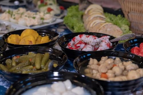 a table topped with bowls of different types of food at Azymut 48C in Stary Folwark