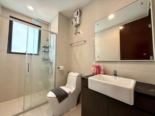 a white bathroom with a sink and a shower at Amberside JB City View 3BR3B 10pax Top Floor at JB Central in Johor Bahru