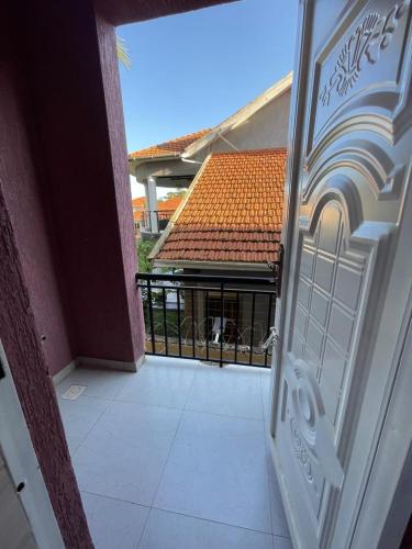 a door to a balcony with a dog in a gate at Posh Apartment Munyonyo in Kampala