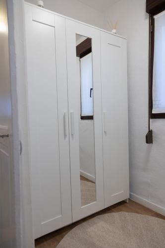 a white cabinet with a mirror in a room at Ametsa !!! VT Cerca de la Playa in Lekeitio