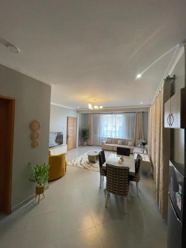a living room with a table and a couch at Posh Apartment Munyonyo in Kampala