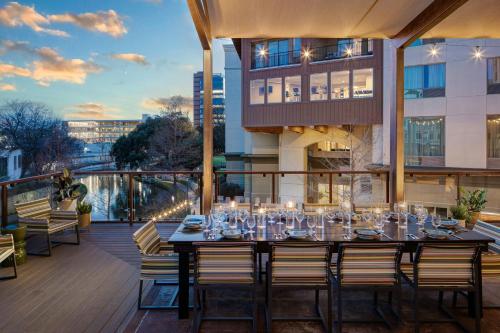 a dining table on the balcony of a building at Sol Cypress, San Antonio, a Tribute Portfolio Hotel in San Antonio