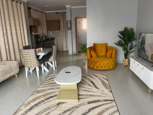 a living room with a couch and a table at Posh Apartment Munyonyo in Kampala