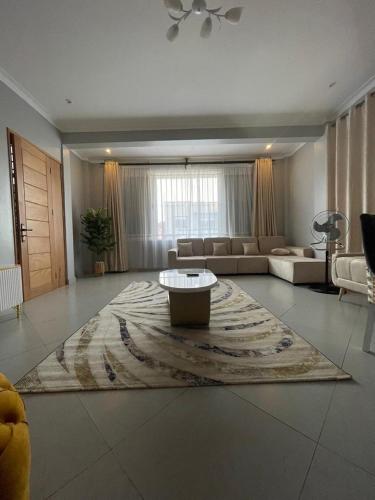 a large living room with a couch and a coffee table at Posh Apartment Munyonyo in Kampala