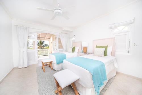 a white bedroom with two beds and a window at Sugar Hill Estate - B307 by Island Villas in Saint James