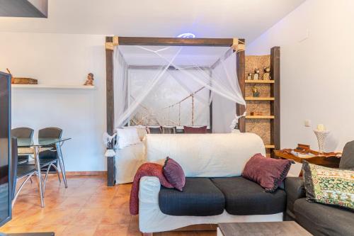 a living room with a couch and a table at RentitSpain Terrazas del sol, Relax Piscina y Golf in Salobreña