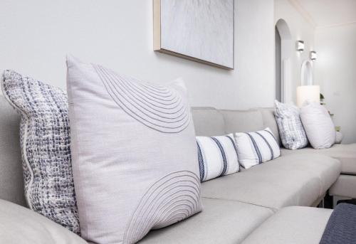 a living room with a white couch with pillows at Sugar Hill Estate - B307 by Island Villas in Saint James