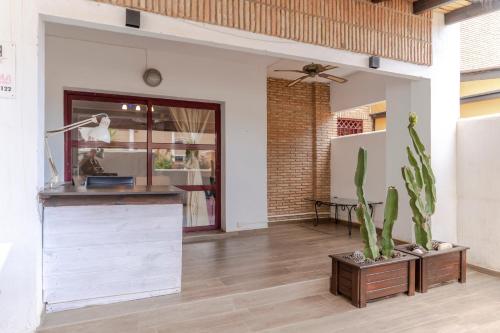 a kitchen with a counter and a cactus at RentitSpain Terrazas del sol, Relax Piscina y Golf in Salobreña