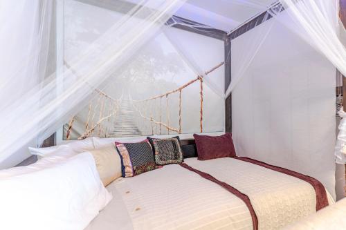 two beds in a room with a window at RentitSpain Terrazas del sol, Relax Piscina y Golf in Salobreña